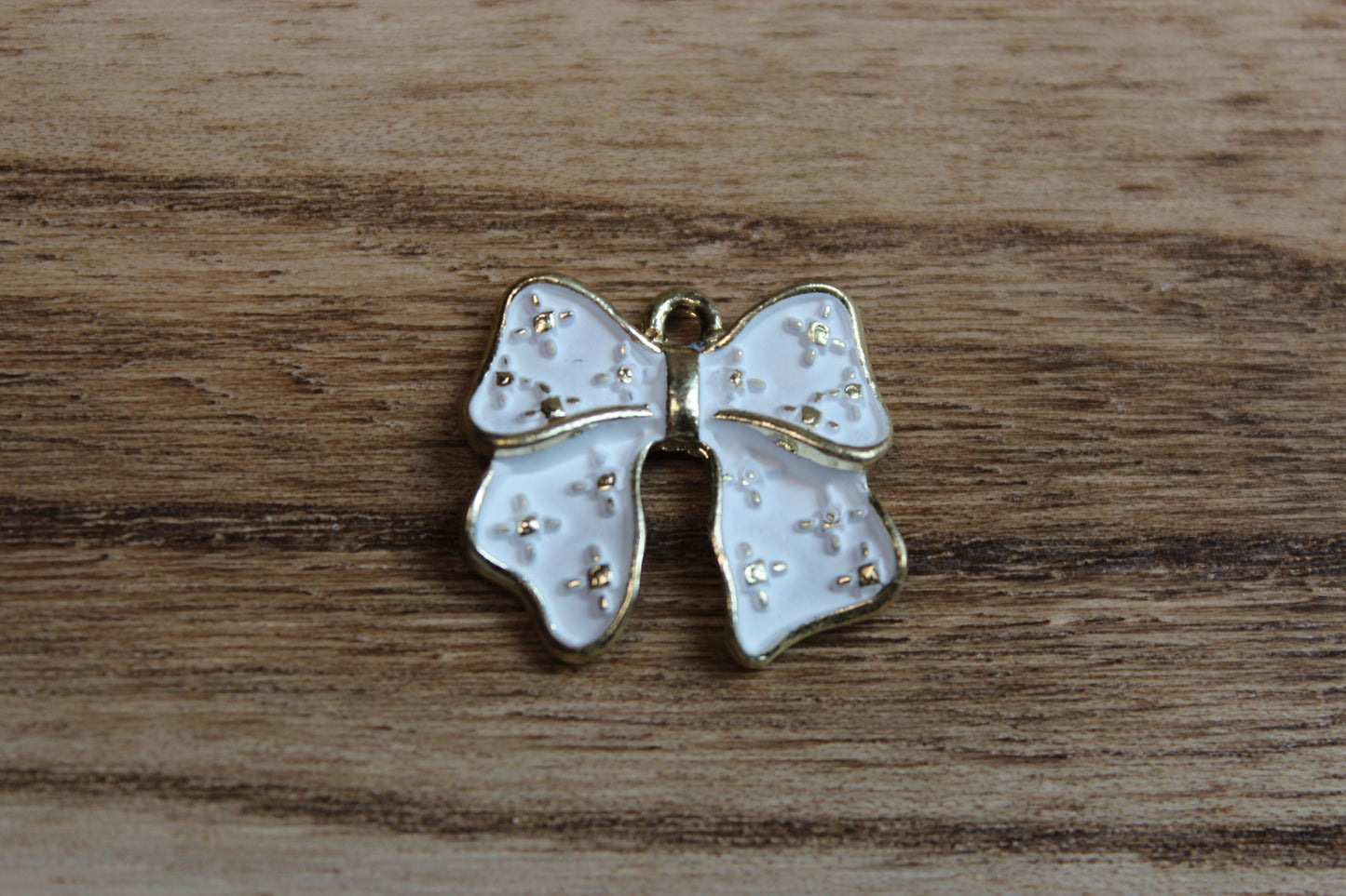 White Bow Charm With Gold Specs